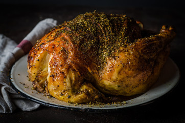 Roasted chicken with zatar or zaatar on dark background. Toned image. Selective focus. Arabic cuisine