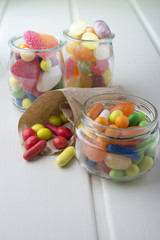 Multicolor candies in glass jars