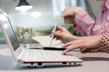 Fototapeta premium Modern Office Background Computer and female Hands touching Keyboard