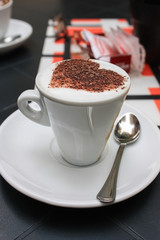A cup of espressino decorated with heart