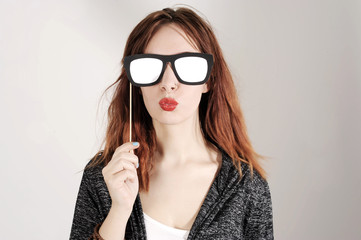 
funny trendy fashion girl with paper glasses playing with emotion