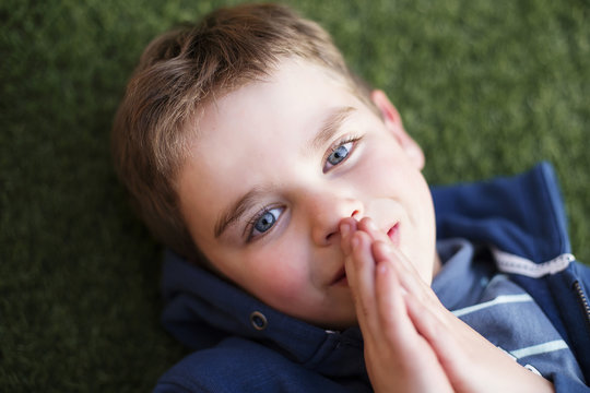 Overhead view of a boy praying