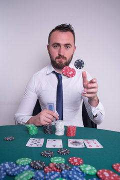 Poker player throwing gambling chips in the air