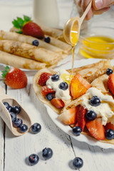 Homemade pancakes with wipped cream and fresh berries