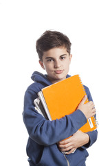 Portrait of little boy holding copybooks over white background