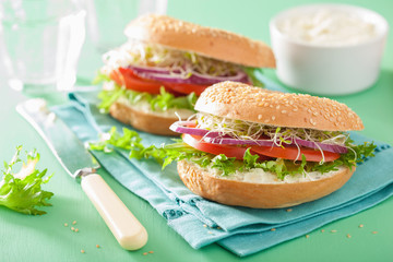 tomato sandwich on bagel with cream cheese onion lettuce alfalfa