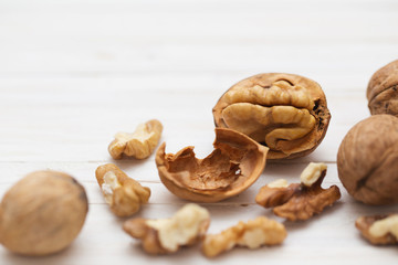 Fototapeta na wymiar walnuts on white wooden background