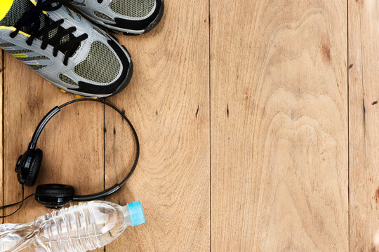 Sport shoes,sneaker and bottle of water on wooden background ,sp