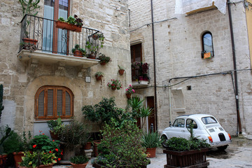 A street decorated with flowers in an old part of Bari, Italy