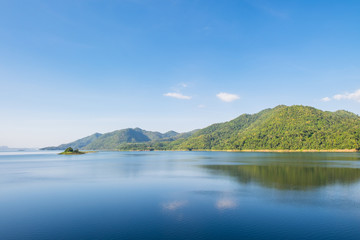 Fototapeta na wymiar Blue sky reflection and mountain on dam at kanchanaburi