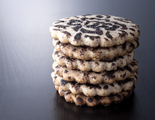 Chocolate biscuits tower on wooden background