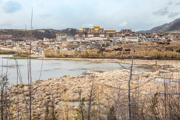Fototapeta premium Landscape with tibetan monastery and lake in Zhongdian city.jpg