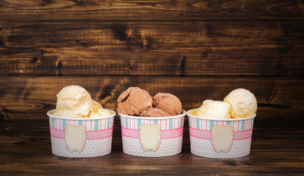 Three sorts of homemade ice cream in paper cups 