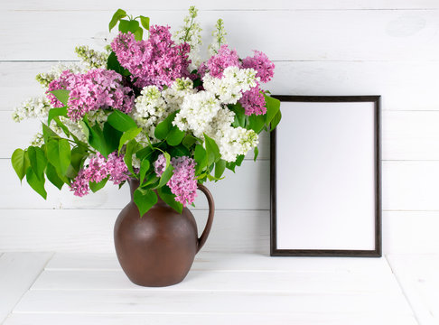 Lilac bouquet in jug with motivational frame