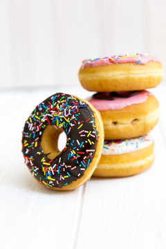 Stack of multi-colored donuts with icing