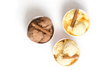 Three different sorts of homemade ice cream in paper cups 