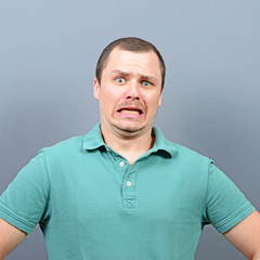 Obraz premium Disgusted man against gray background