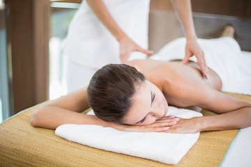 Obraz na płótnie Canvas Woman receiving back massage at spa