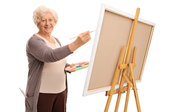 Senior Lady Painting On A Canvas