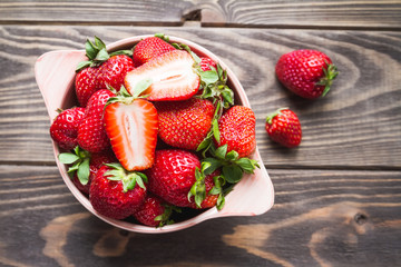 strawberries in a bowl on a old table