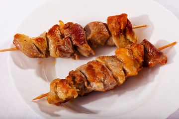 Skewers on white plate