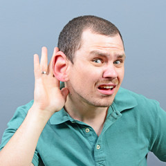 Portrait of man with huge ear listening on private conversation
