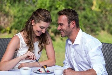 Happy couple sitting in park