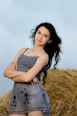 Fototapeta na wymiar Portrait of beautiful girl in a field