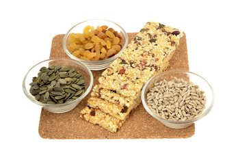 Sesame seed ,pumpkin, sunflower seeds, raisins and nut energy bar, white background.