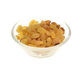 Raisins in a glass bowl. Isolated on white.