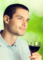 Thinking man with redwine, outdoors