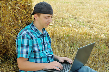 Naklejka na ściany i meble a business man in a countryside with a laptop