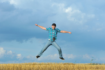 Boy jumping, running against blue sky