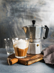 Glass of coffee with ice cream on rustic wooden board and steel Italian Moka pot