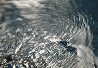 Abstract water ripples in a streaming river