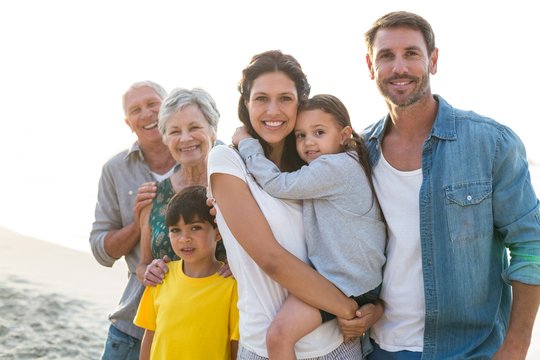 Happy family posing at the beach - Powered by Adobe