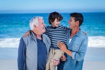 Male family members posing at the beach