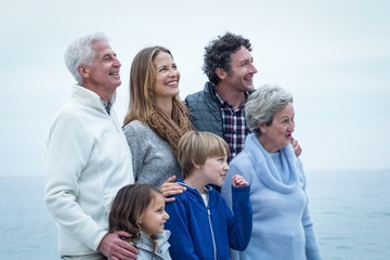 Cheerful family looking away at beach