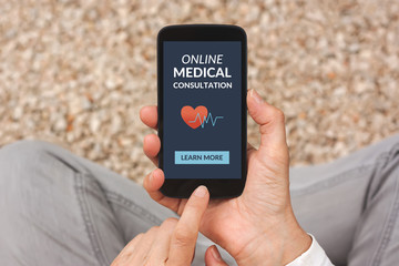 Hands holding smart phone with online medical consultation concept on screen. All screen content is designed by me