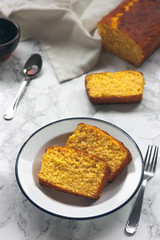 Slices of orange sponge cake and caramel sauce