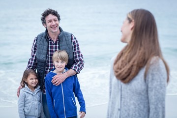 Fototapeta premium Smiling father with children looking at mother