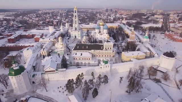 Aerial views. Beautiful winter Russia. Flying over the Trinity Lavra of St. Sergius. Frozen old monastery and church covered with snow. Village. Religious. Unique footage from quadcopter drone.