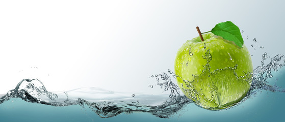 Postcard, ripe green apple fruit in a spray of water. 