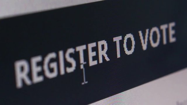 Super Macro close up of black online banner saying 'Register to Vote' shot at pixel level with special lenses. User then moves cursor around before camera dolly right to exit the shot