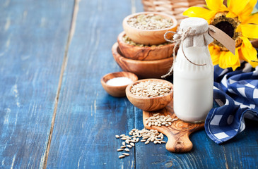 Raw vegan sunflower seed milk in glass bottle, selective focus