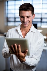 Young man using digital tablet in office