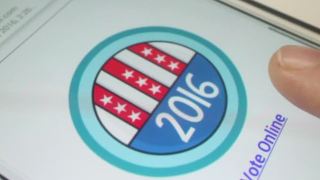 Closer Macro CU of voter touching and scrolling along the page of a phablet and pressing a 2016 American flag style interactive voting button. User then scrolls around on following page 