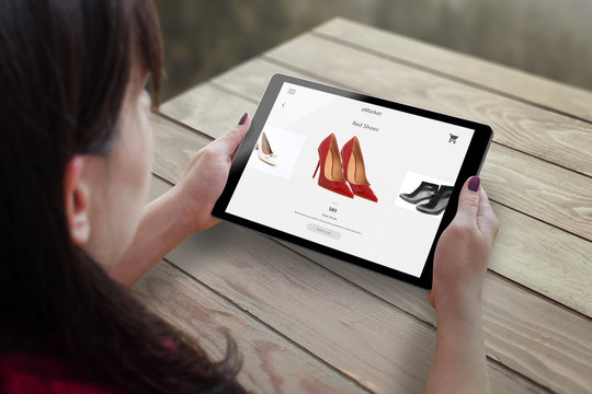 Shopping with tablet. Woman buy red shoes on online market.