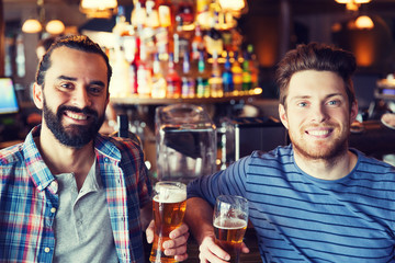 happy male friends drinking beer at bar or pub