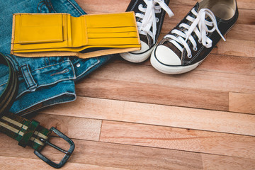 Vintag jean,cloths and accessories on a wooden background